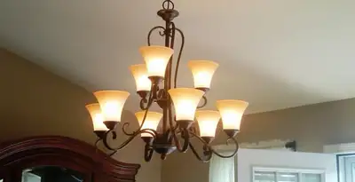 Classic ceiling chandelier installation with warm lighting in Chandler, AZ