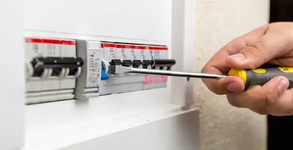 electrical panel upgrade service showing technician adjusting circuit breakers during system upgrade in Chandler, AZ