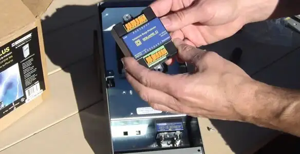 Electrician installing whole home surge protection unit inside main electrical panel in Chandler, AZ