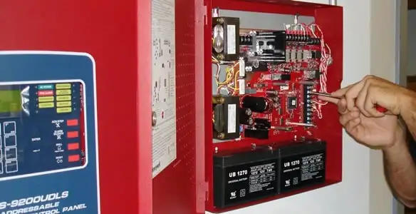 fire alarm installation service showing technician configuring fire alarm control panel in Chandler, AZ