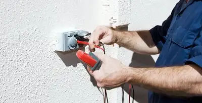 Electrician performing home electrical outlet and wiring inspection in Chandler, AZ