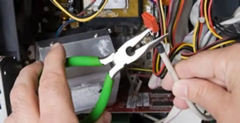Licensed electrical contractor performing electrical repair with tools in Phoenix, AZ