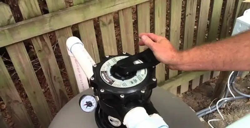 pool pumps service showing professional adjustment of pool pump control system in Chandler, AZ